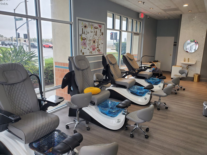 Modern pedicure station at a nail salon designed by AtoZ Construction, featuring luxurious chairs, large windows for natural light, and elegant interior decor.Picture