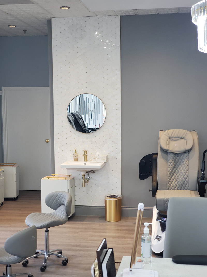 Elegant nail salon interior designed by AtoZ Construction, featuring a sleek pedicure chair, stylish decor, and a modern wash station with gold accents.Picture