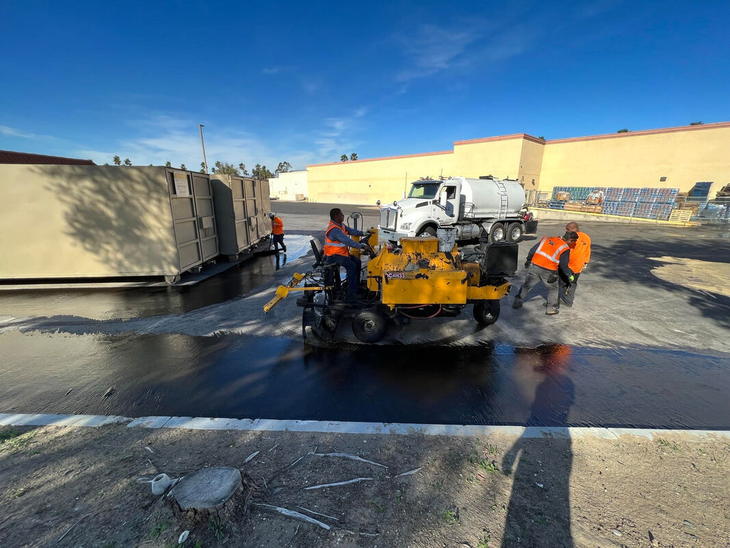 Professional paving crew from AtoZ Construction working on a commercial parking lot, showcasing expertise in asphalt application and project efficiency.Picture